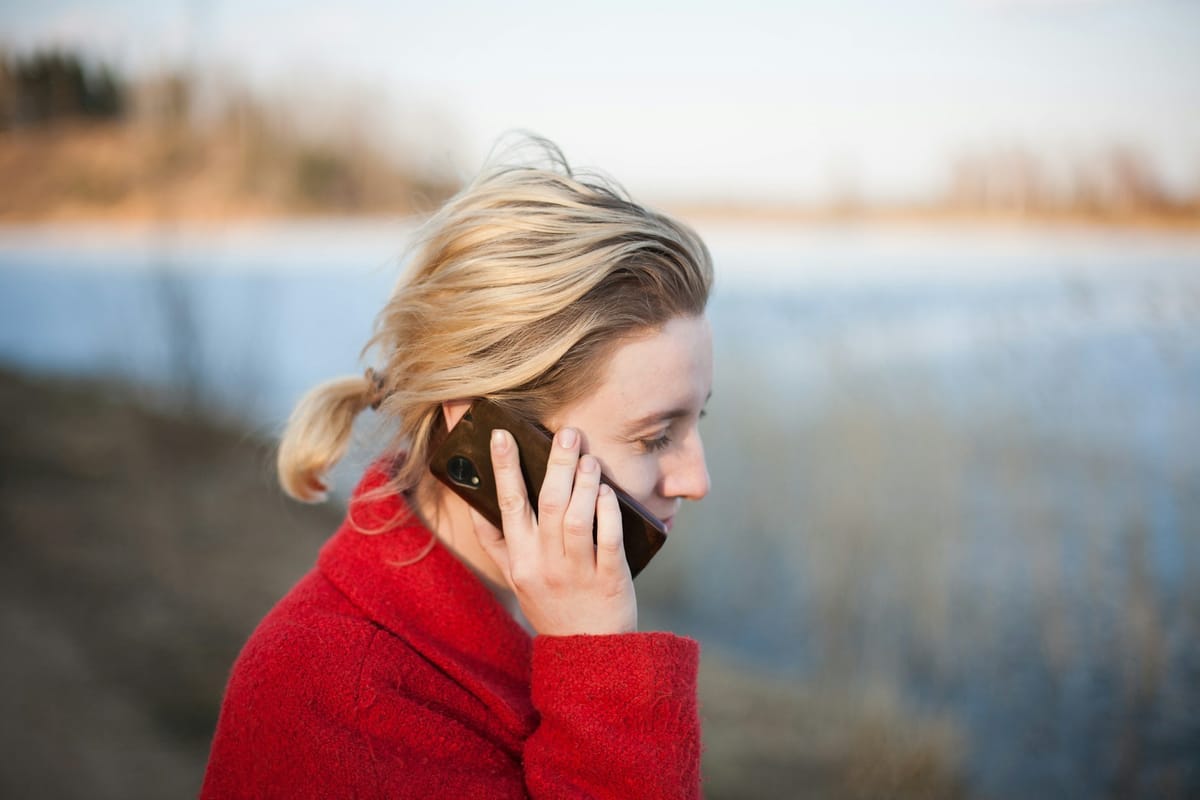 A woman taking a phone call outdoors