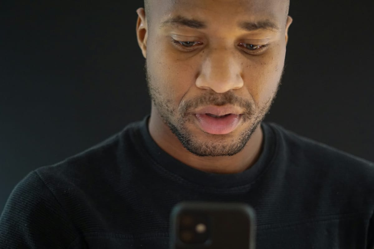 A man looking down at his phone