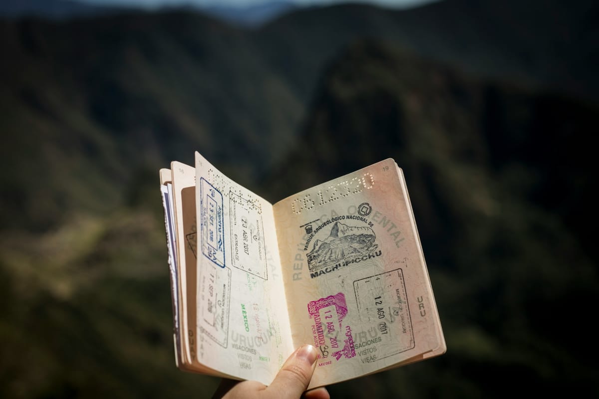 A hand holding an open passport