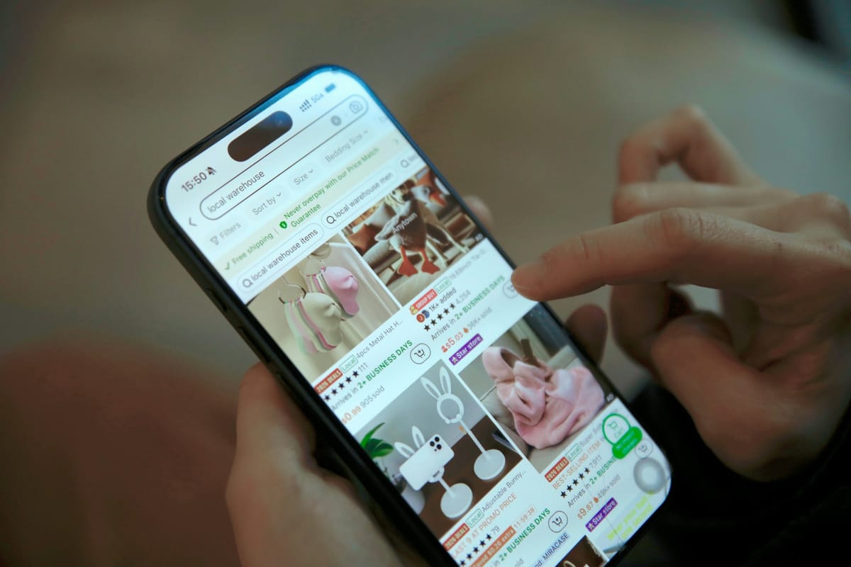 A person scrolling through an online shop on a phone