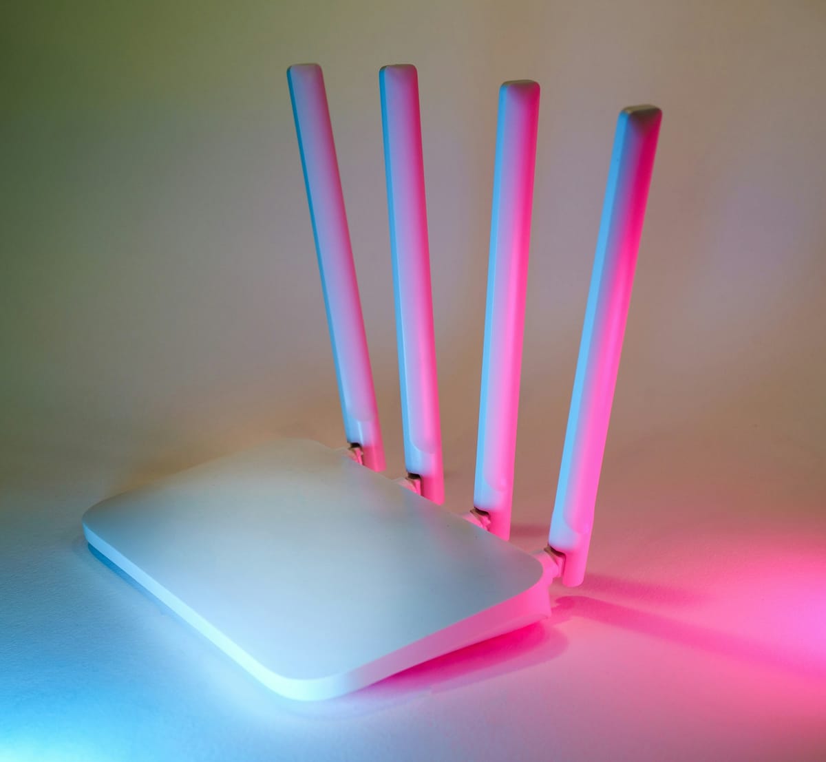 A white Wi-Fi router with four antennas
