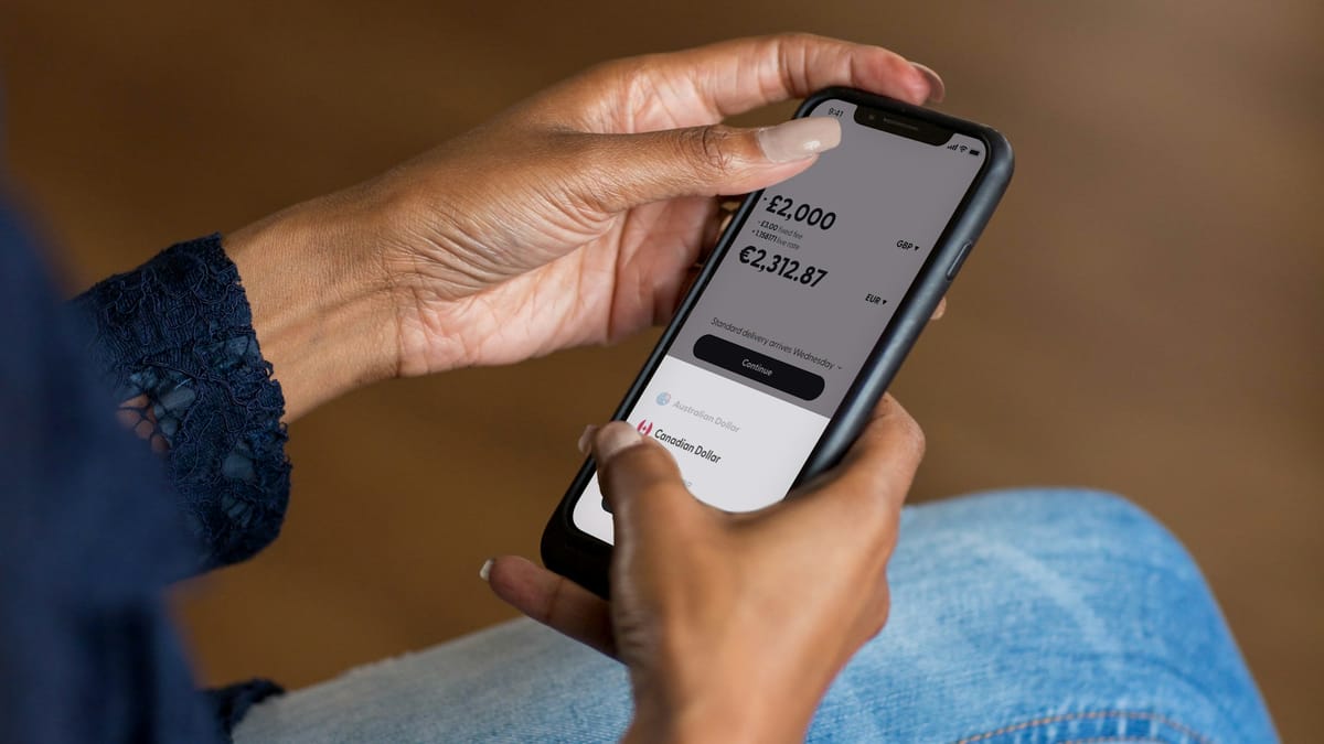 Hands holding a phone showing an account balance