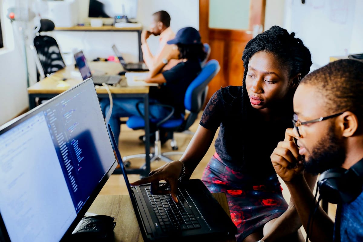 Two people working together at a computer