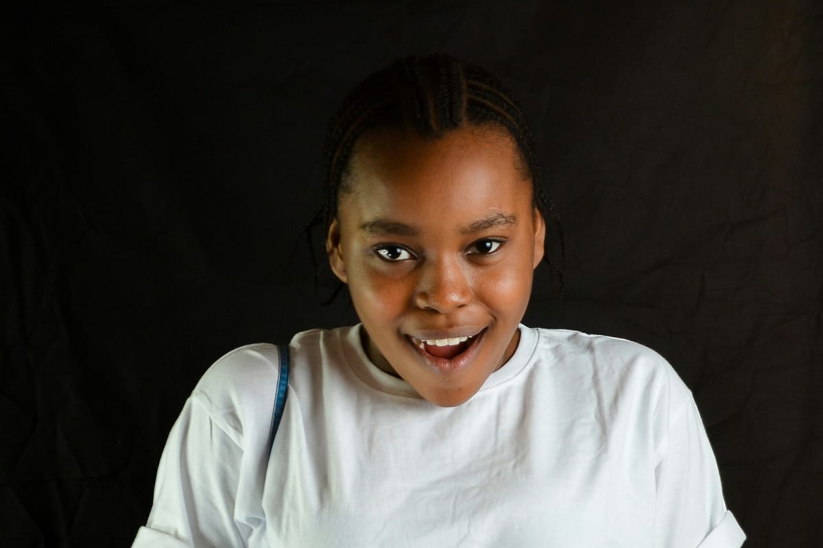 A young woman looking surprised and delighted at her phone