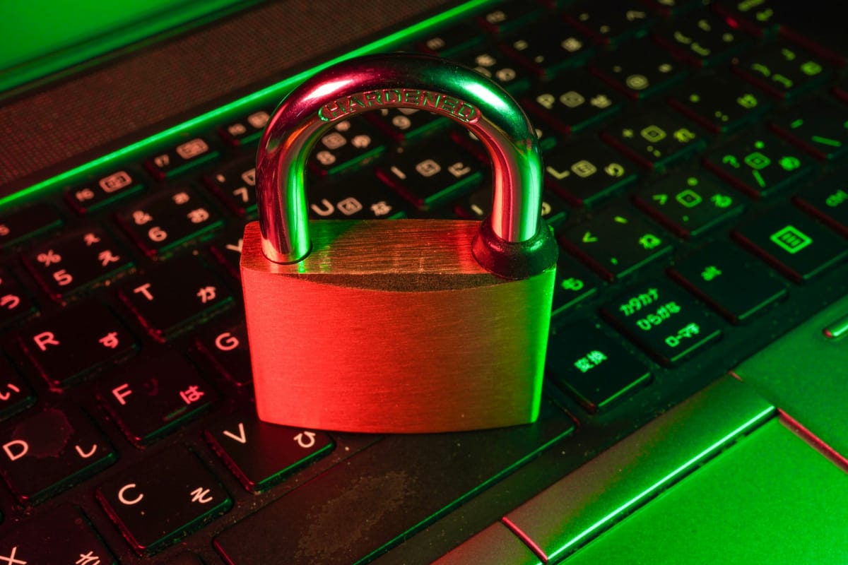 A red padlock on a black computer keyboard