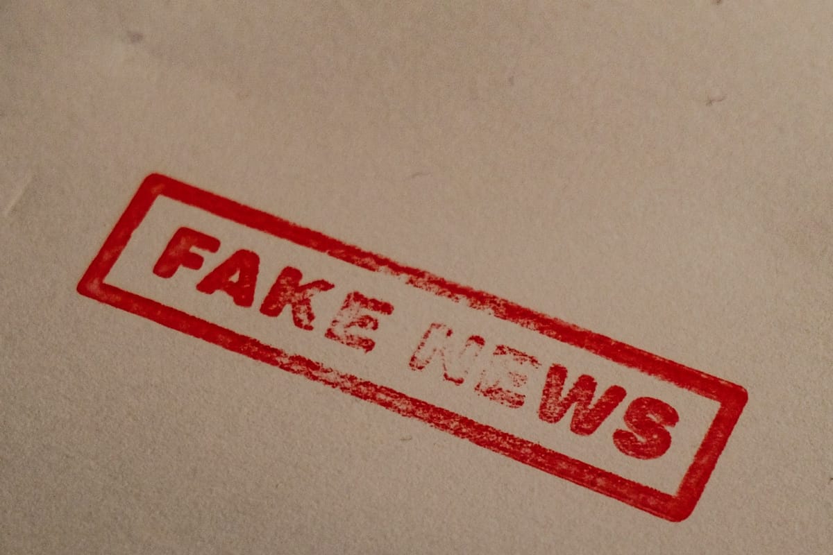 A red ‘fake news’ stamp on paper