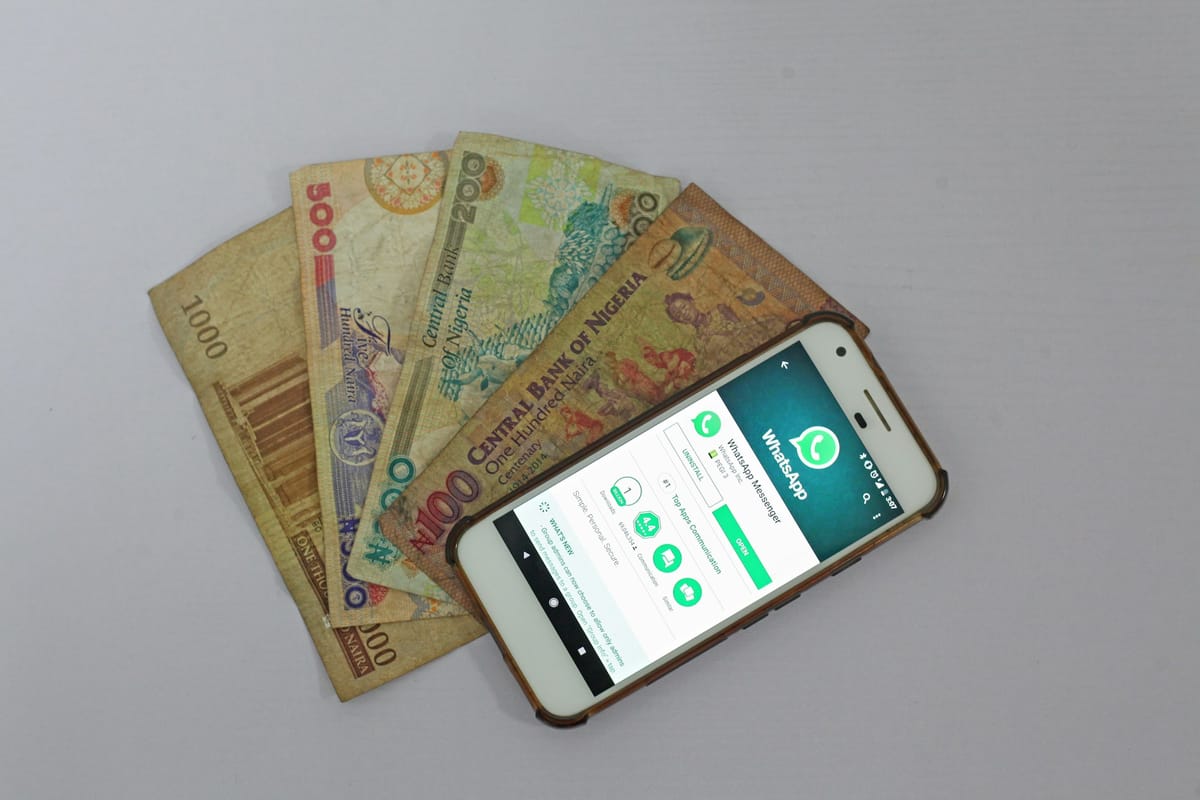 A smartphone lying on top of banknotes