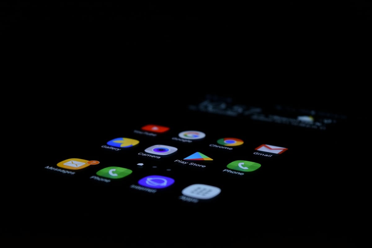 A smartphone screen full of app icons glowing in the dark