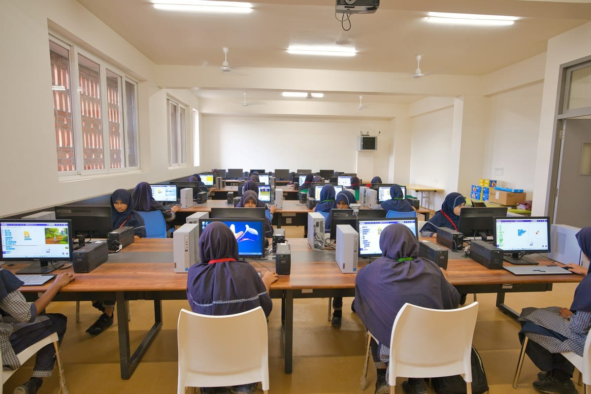 Students working at computers in a bright computer lab