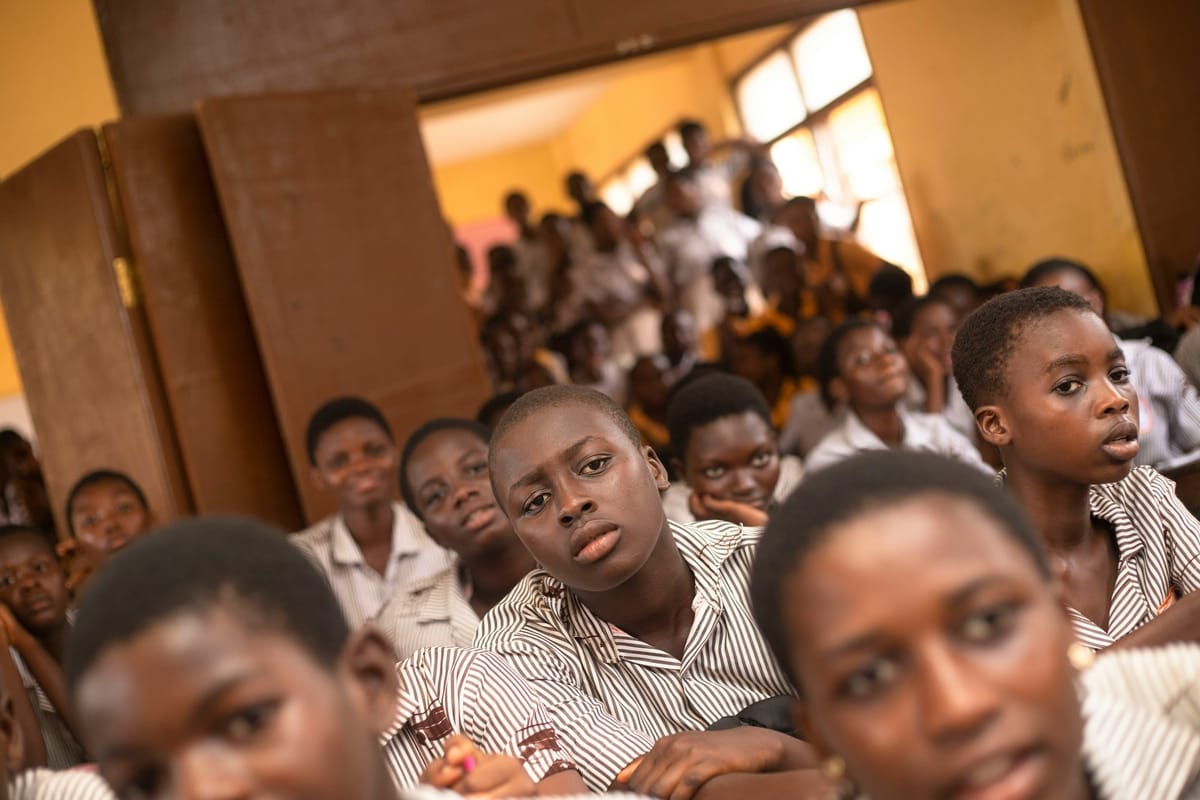 A classroom full of young students in uniform