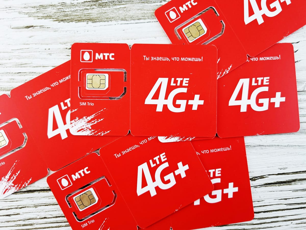 Red SIM cards spread on a wooden table