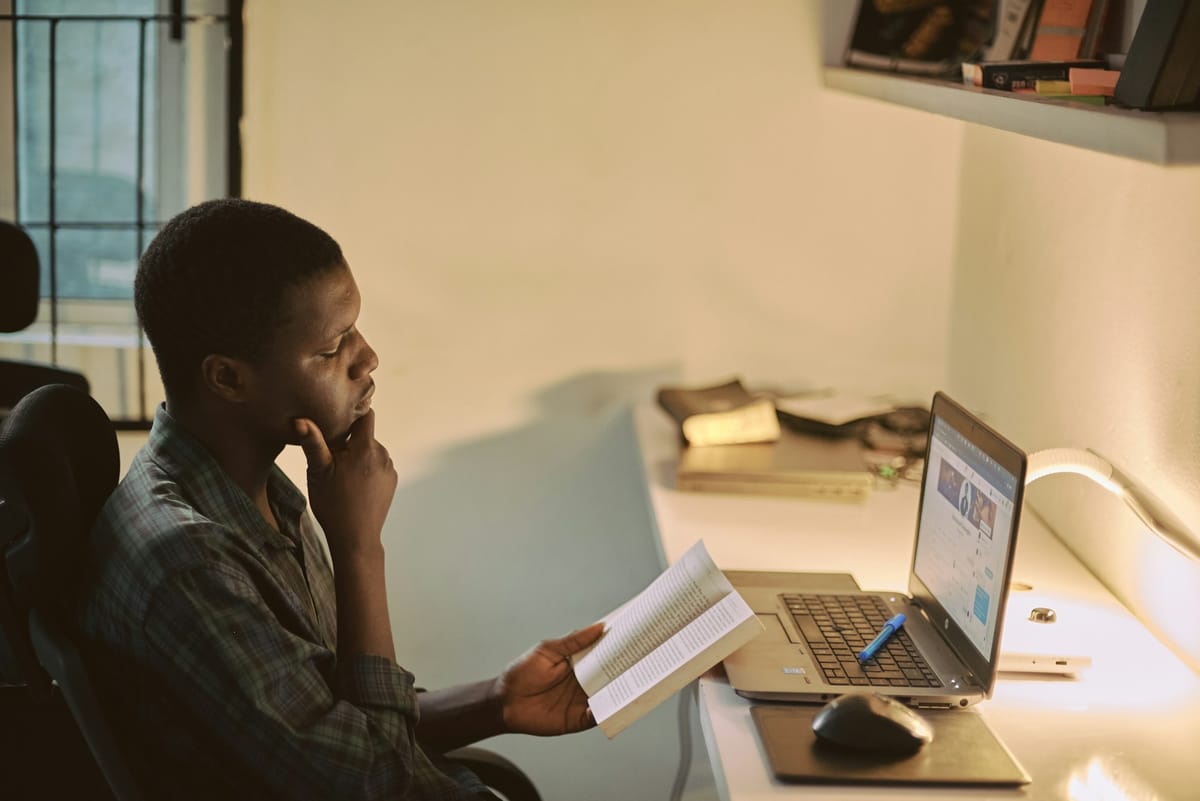 A young man reading a document at a desk