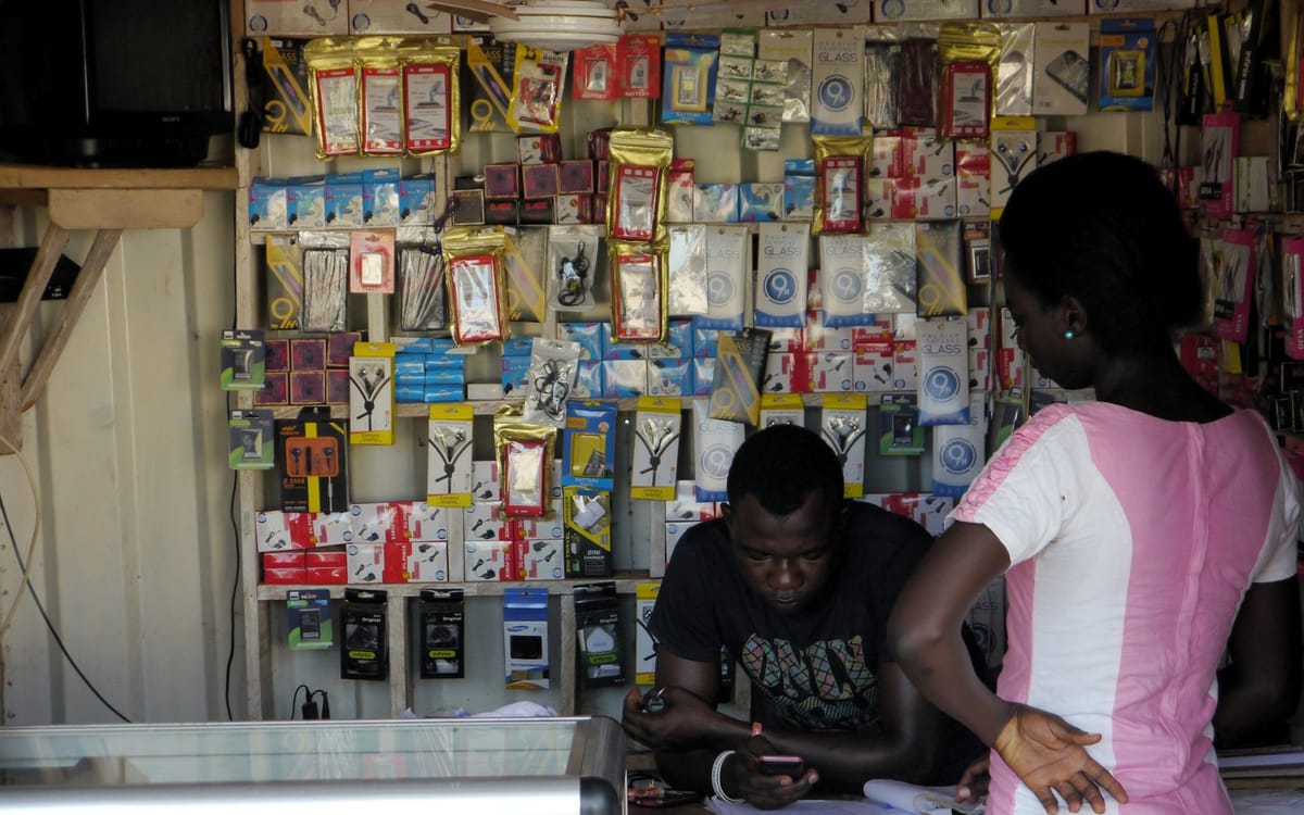 A phone accessories shop with customers at the counter