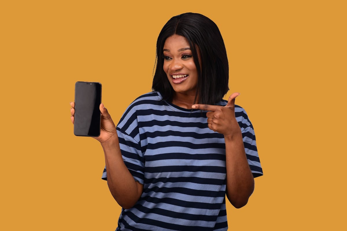 A woman pointing at the phone in her hand