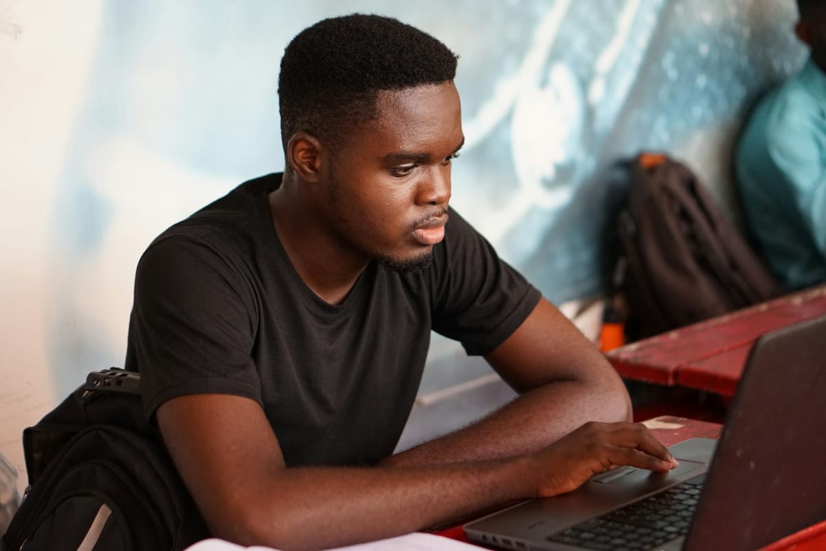 A young man concentrating on his laptop