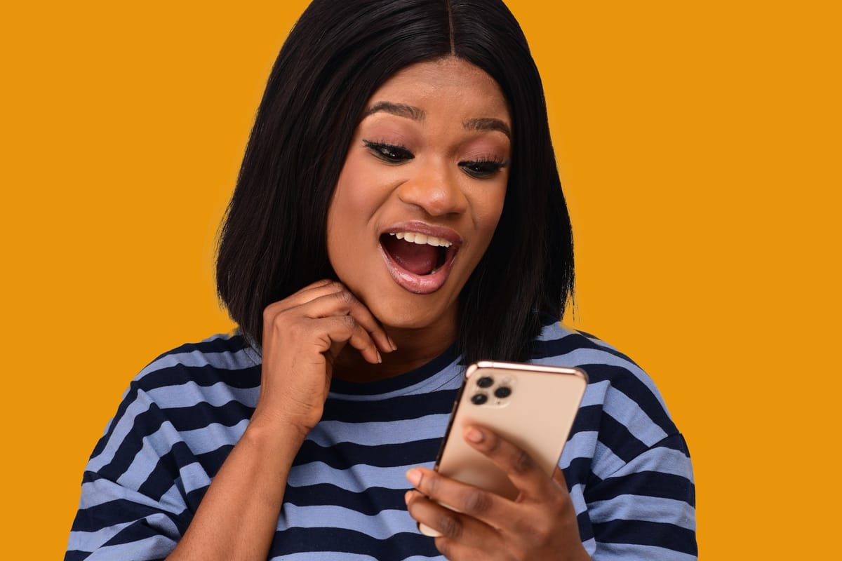 A shocked woman looking at her phone
