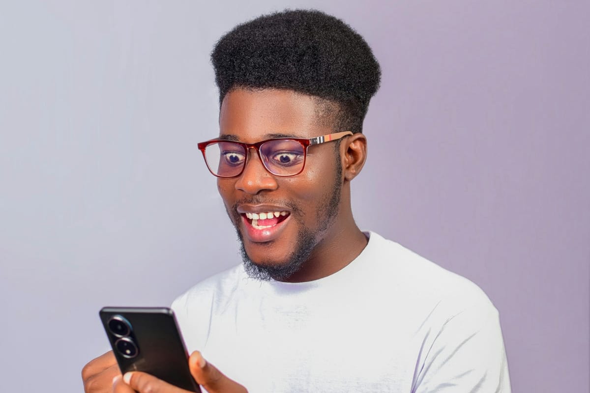 A surprised young man staring at his phone