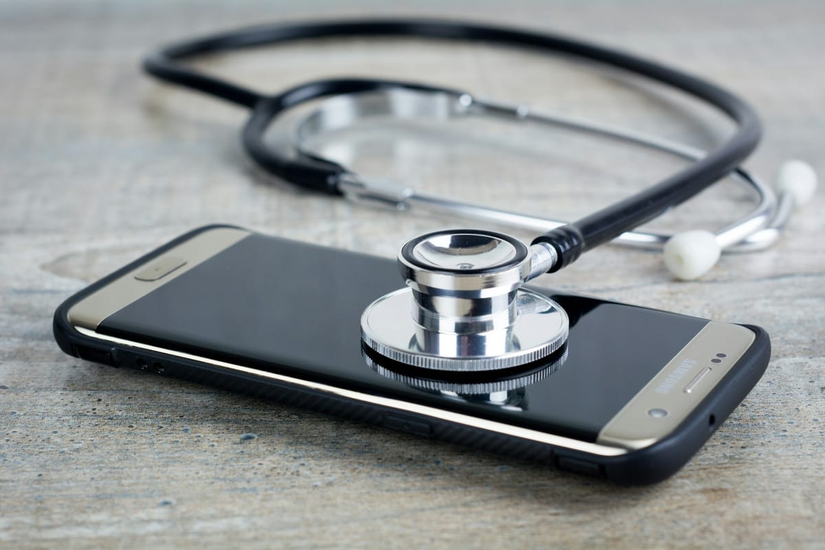A stethoscope resting on a smartphone