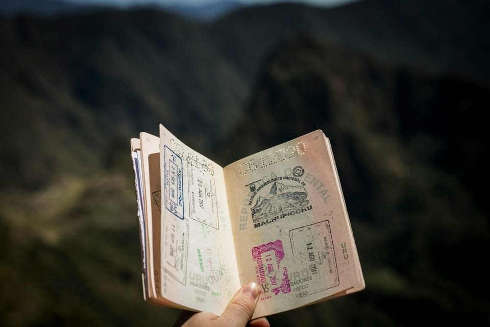 A hand holding an open passport