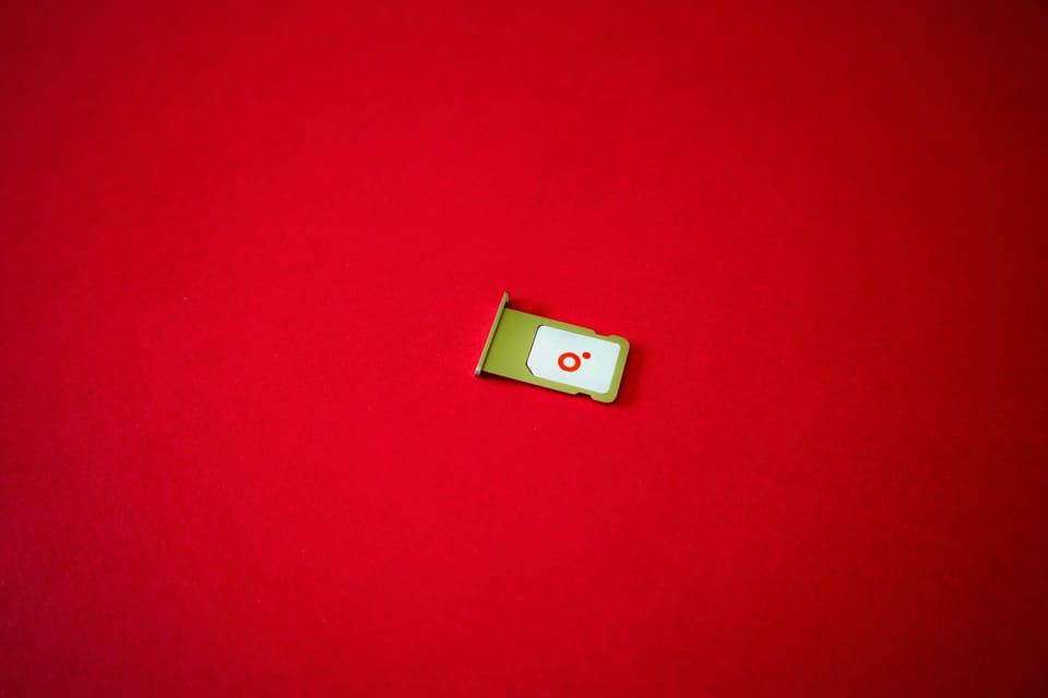 A SIM card on a bright red surface