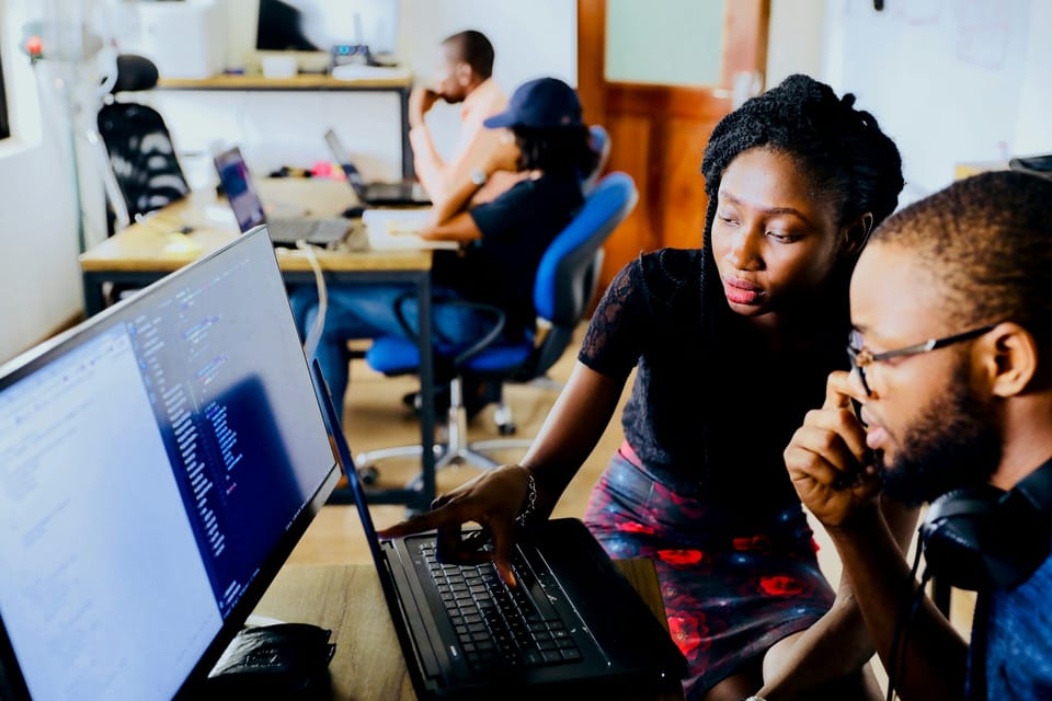 Two people working together at a computer