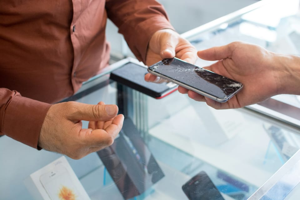 Two people looking at a mobile phone together