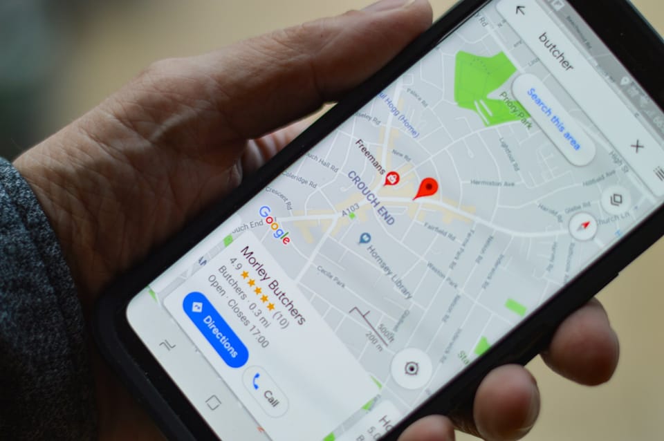 A hand holding a phone showing a map