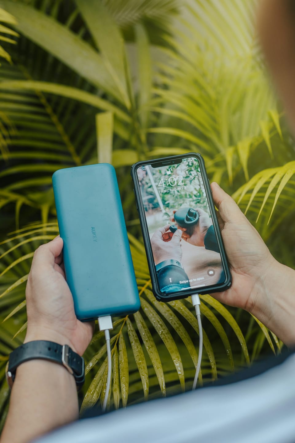 A smartphone and a green power bank
