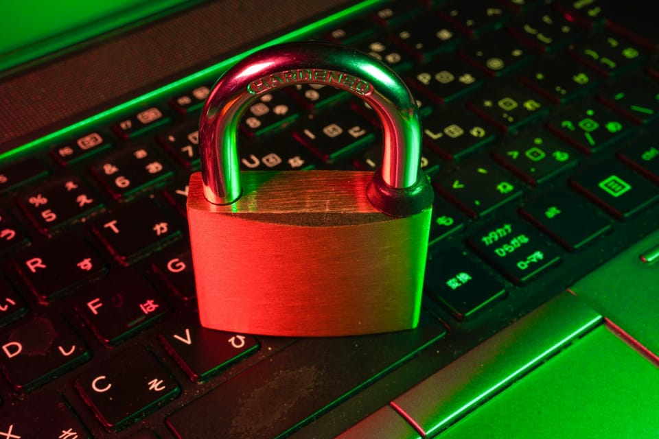 A red padlock on a black computer keyboard