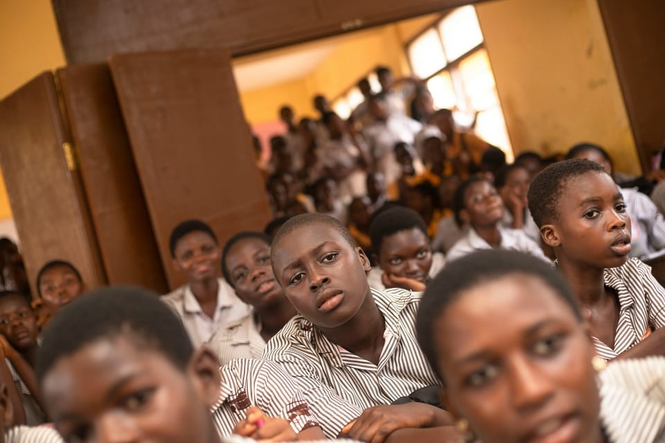 A classroom full of young students in uniform