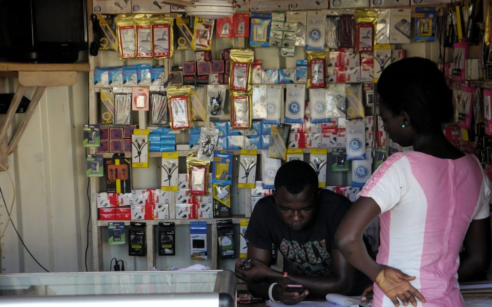 A phone accessories shop with customers at the counter