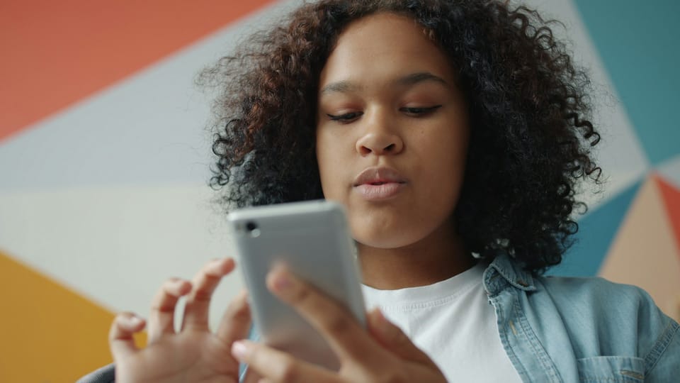 A young woman scrolling on her smartphone