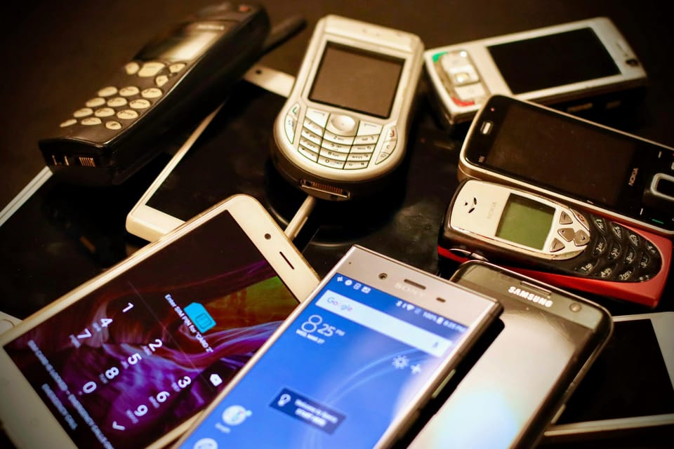 A pile of old and new mobile phones