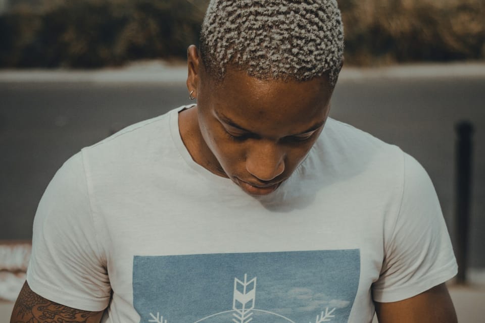 A young man looking down at his phone