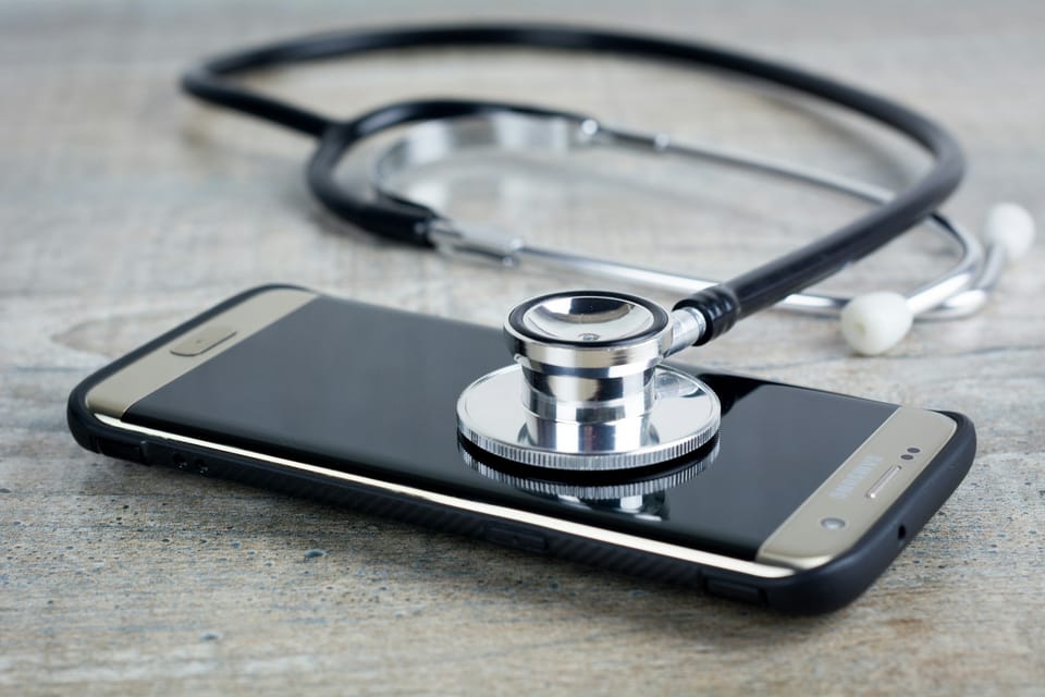 A stethoscope resting on a smartphone
